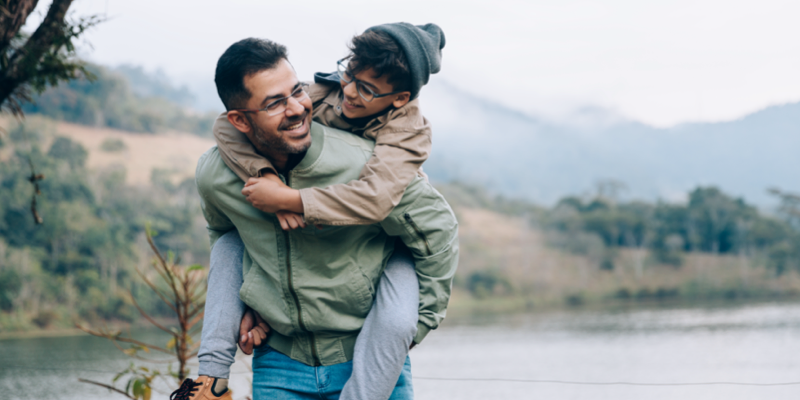 A parent giving a child a piggyback ride