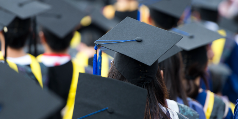 A group of graduates wearing caps and gowns